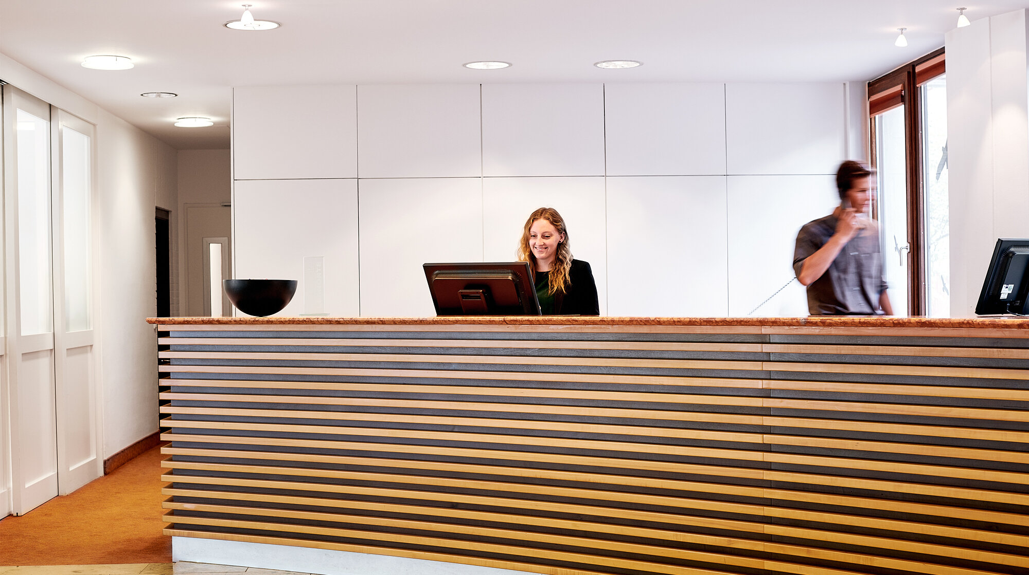 Freundlicher Empfangsbereich der Akademie Westerham mit Rezeption und Mitarbeitenden