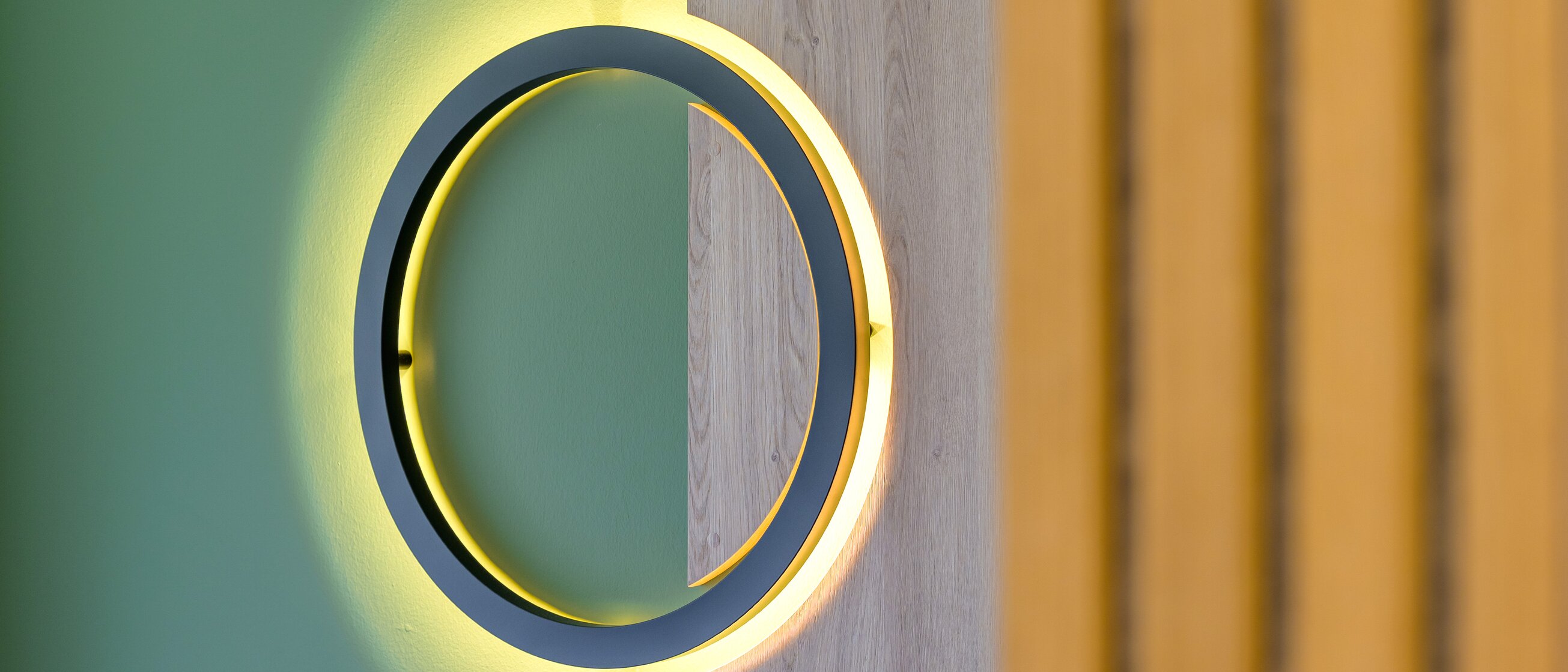 Detailaufnahme einer modernen runden Wandlampe mit indirekter Beleuchtung im Zimmerdesign der Akademie Westerham