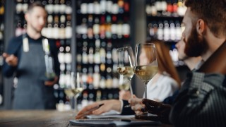 Closeup glasses White wine tasting in restaurant with lecture from male sommelier.