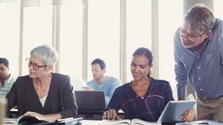 Students studying in adult education classroom