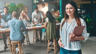 Group of young business people are working together in modern office. Creative people with laptop, tablet, smart phone, notebook. Successful hipster team in coworking. Freelancers.