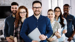 Portrait of successful young business team posing in office